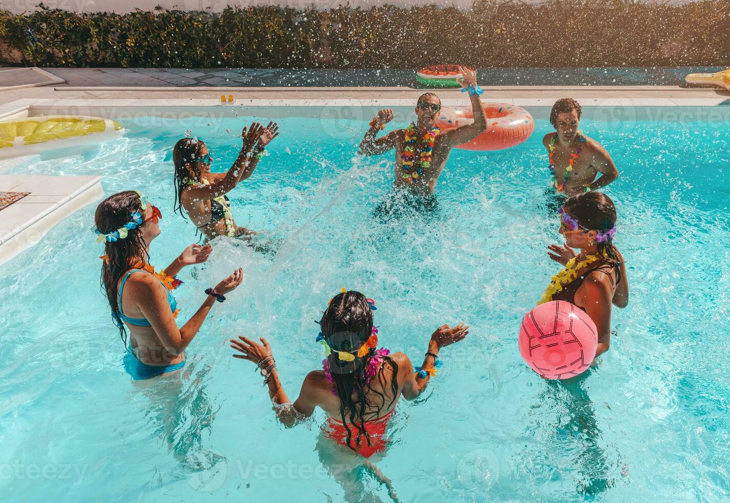 Group of friend play together in the swimming pool photo