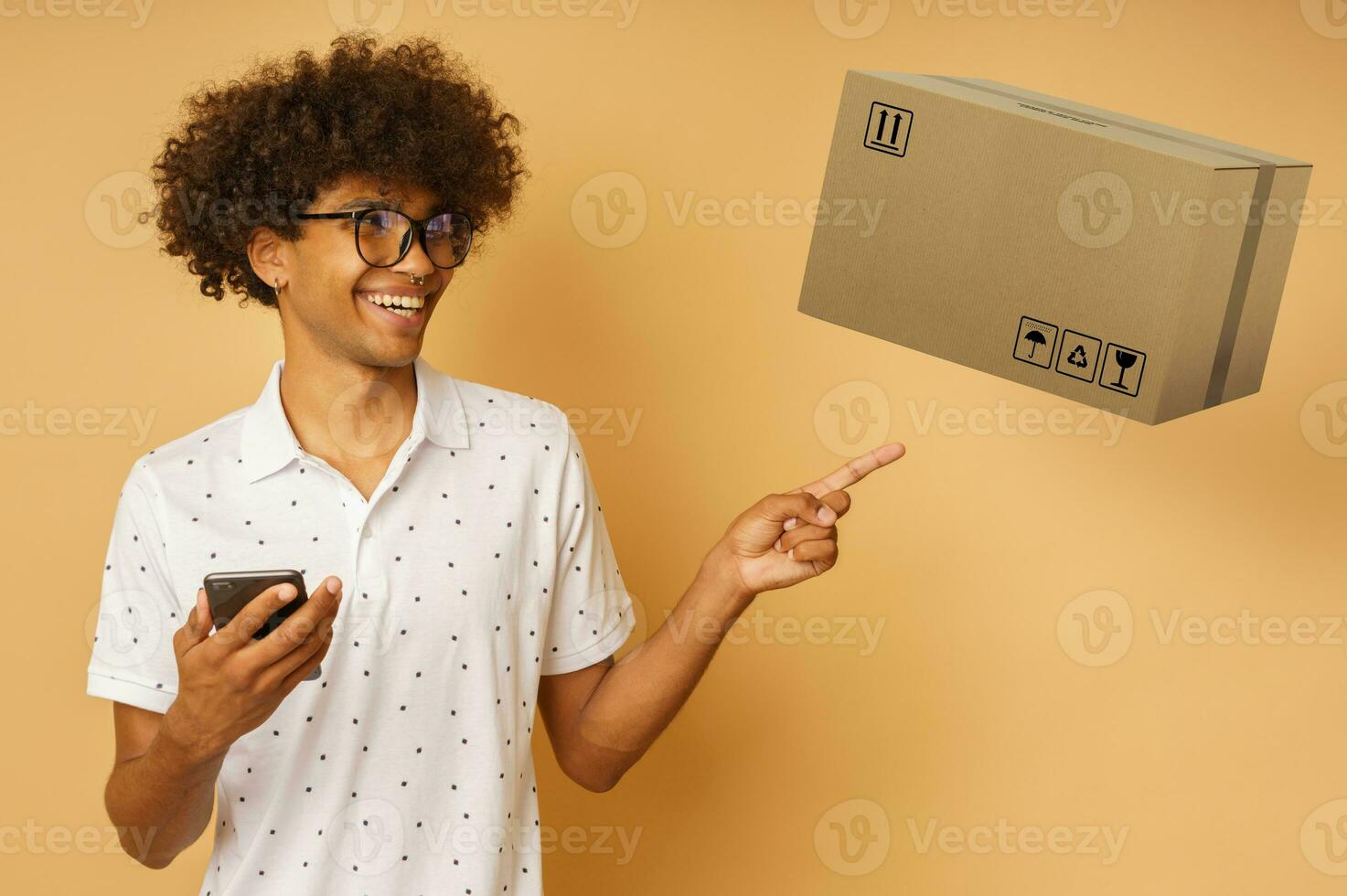 Happy man with glasses indicates something with hand photo