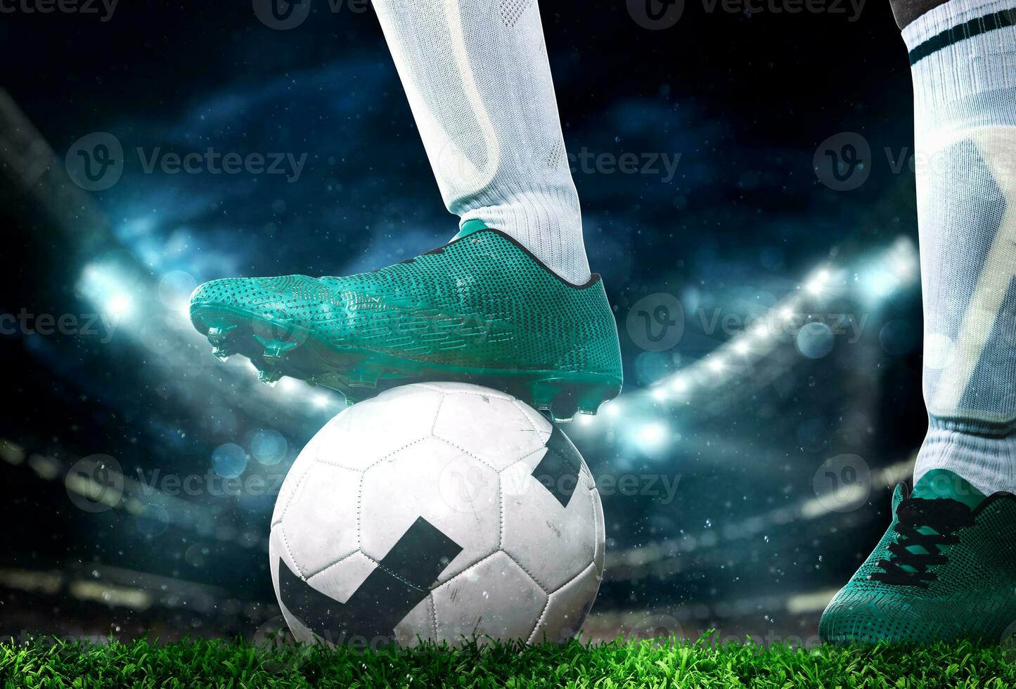 Close up of a soccer striker ready to kicks the ball at the stadium photo