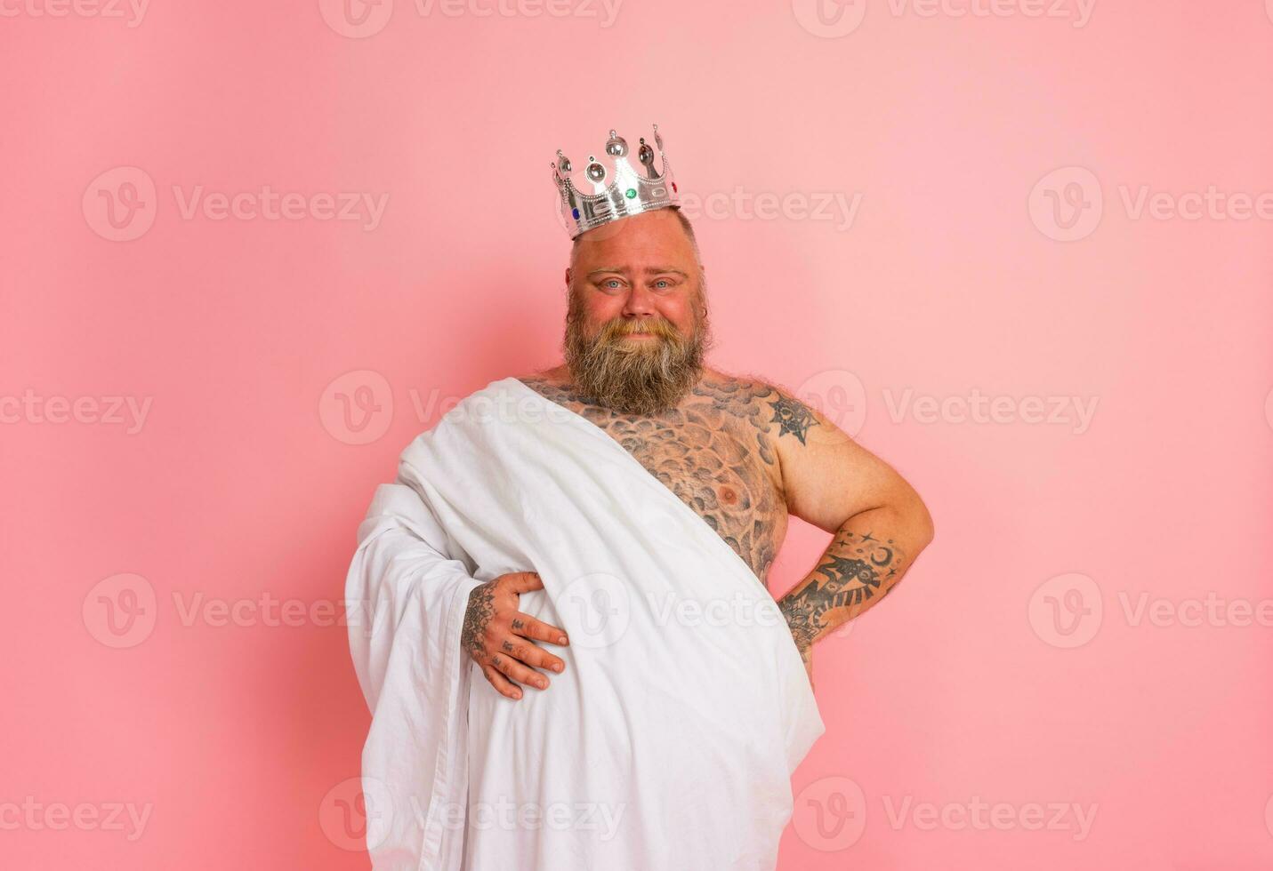 Funny man acts like an important king with a crown above the head photo