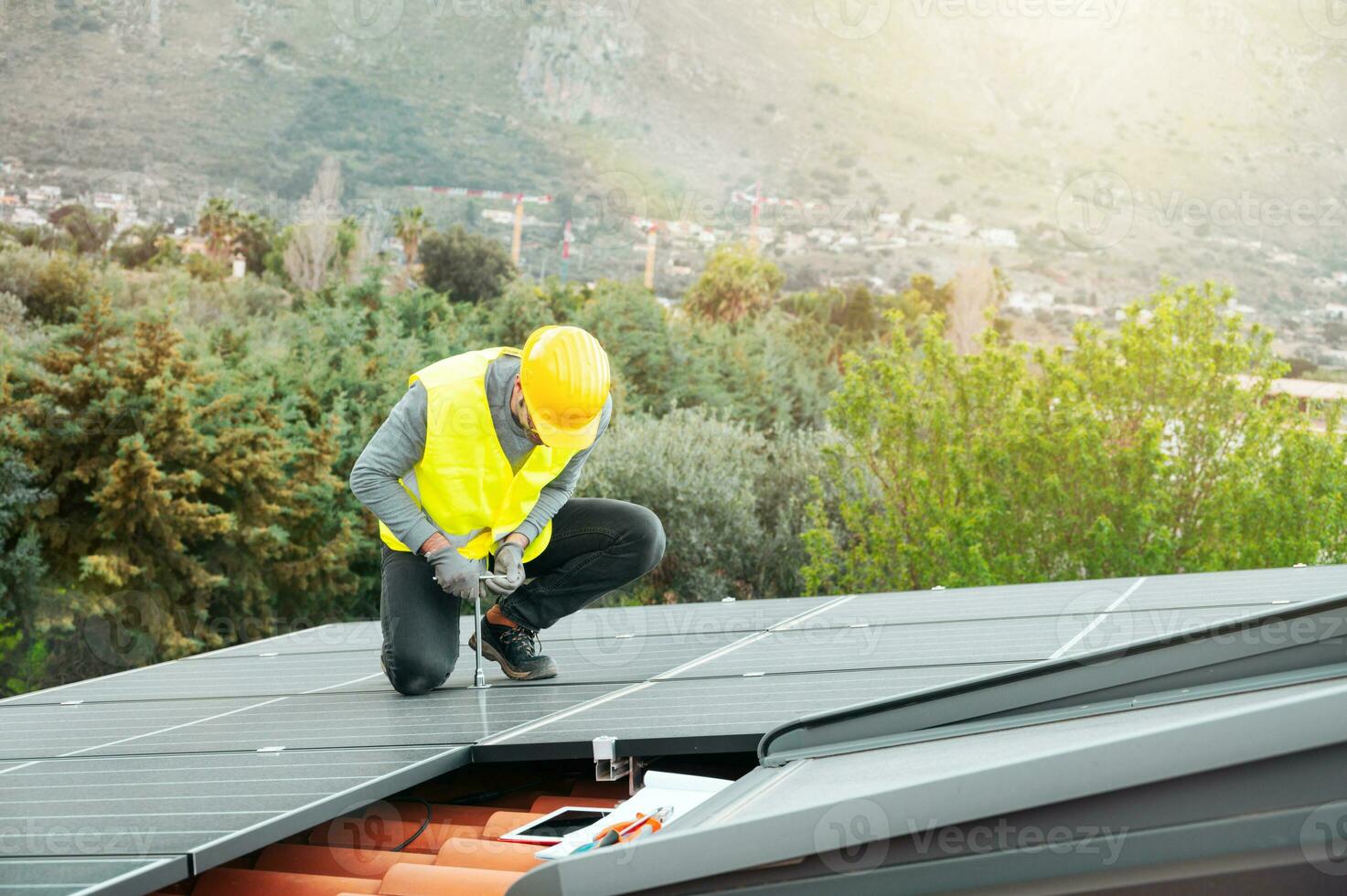 Workers assemble energy system with solar panel for electricity photo