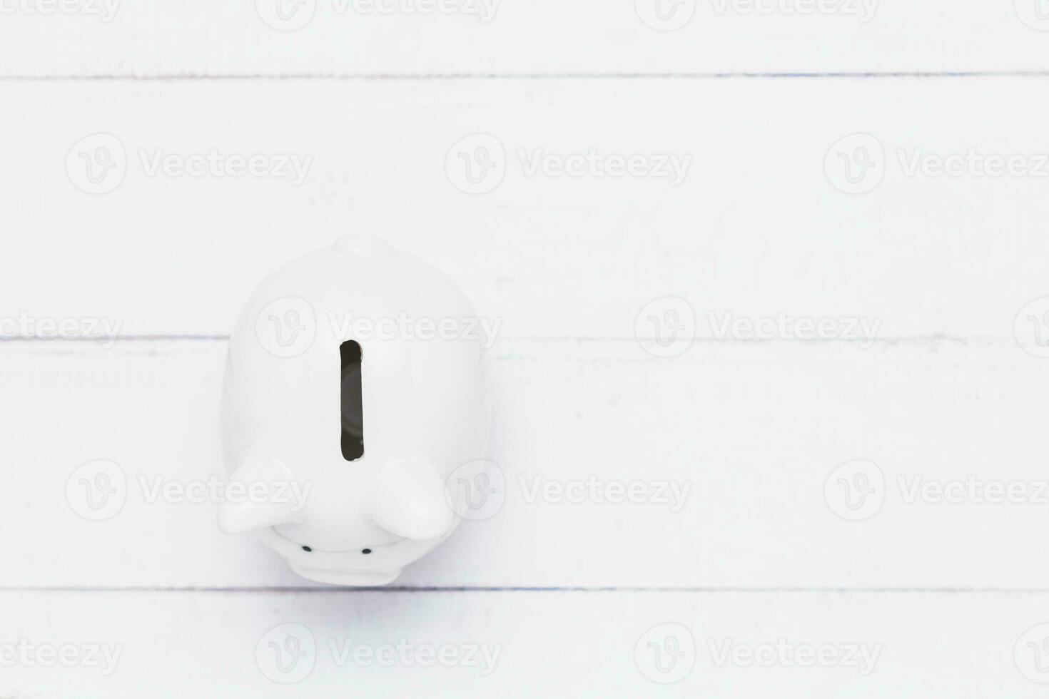 Saving piggy bank on white table background for investment, business, finance and saving money concept photo