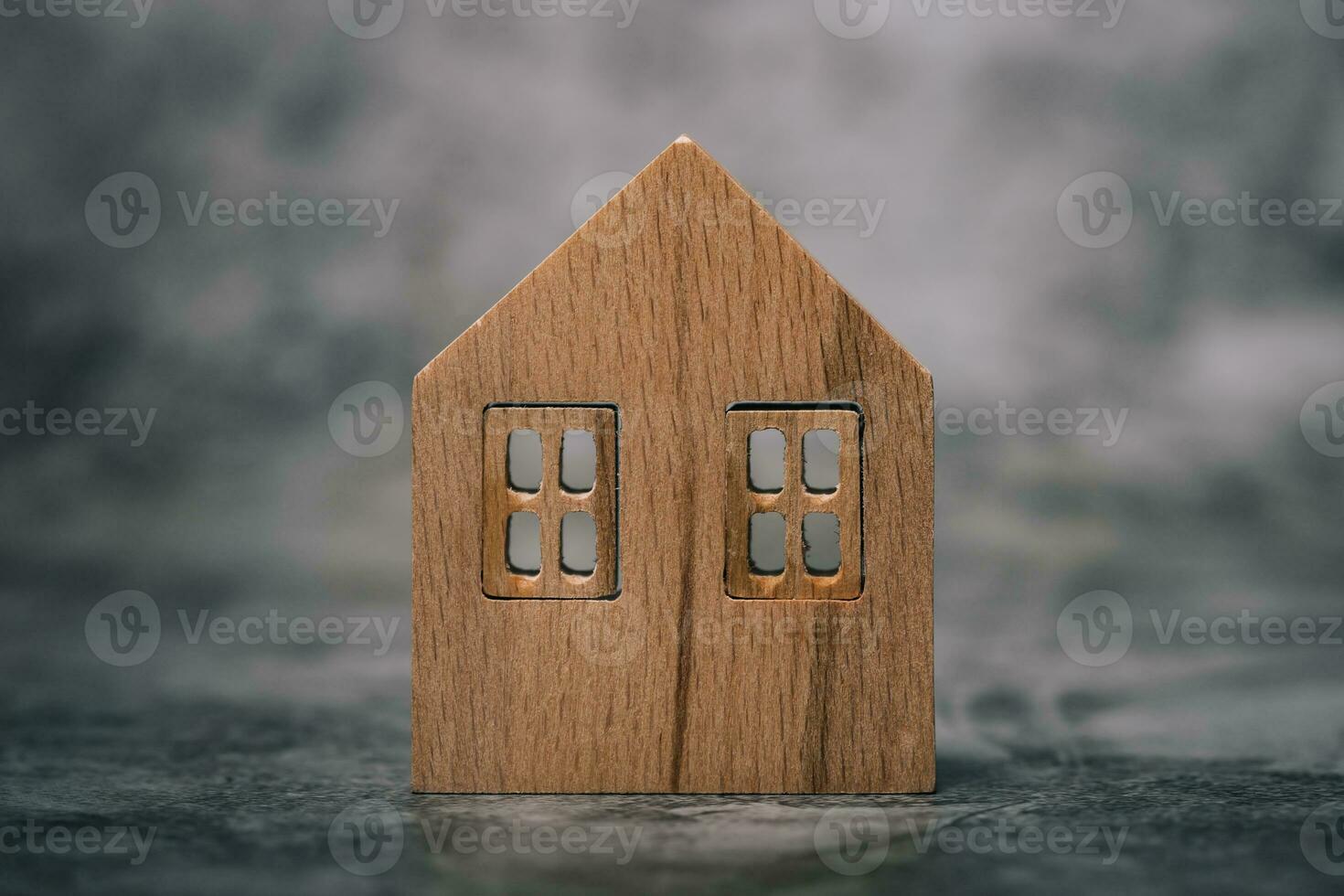 Wooden house model on dark background photo