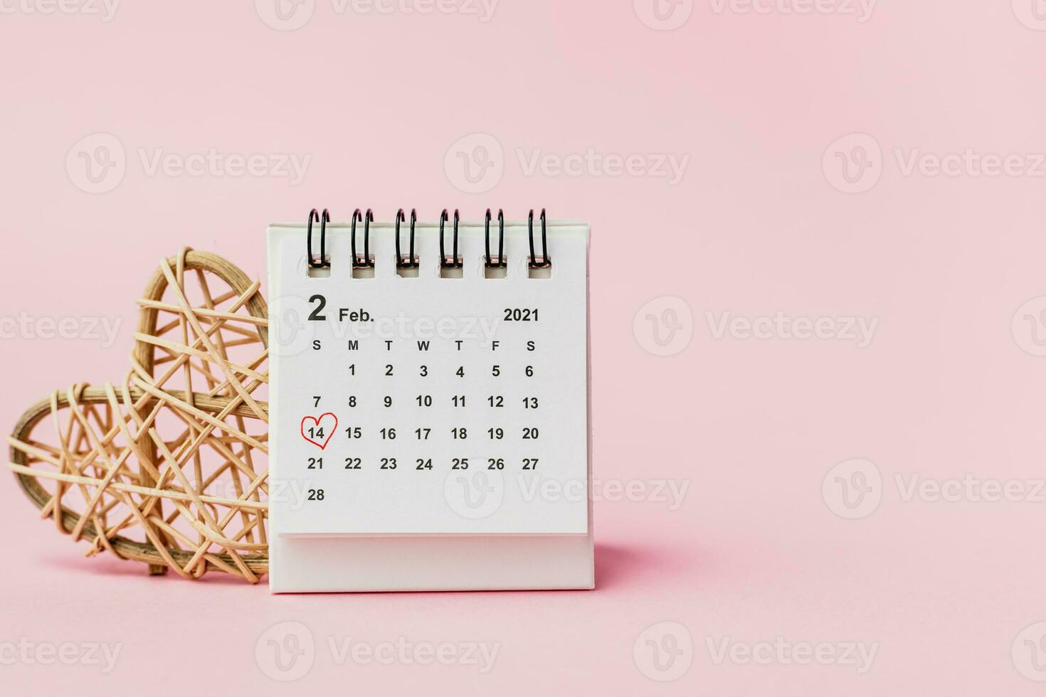 Calendar with red heart shaped marking on date February, 14 photo