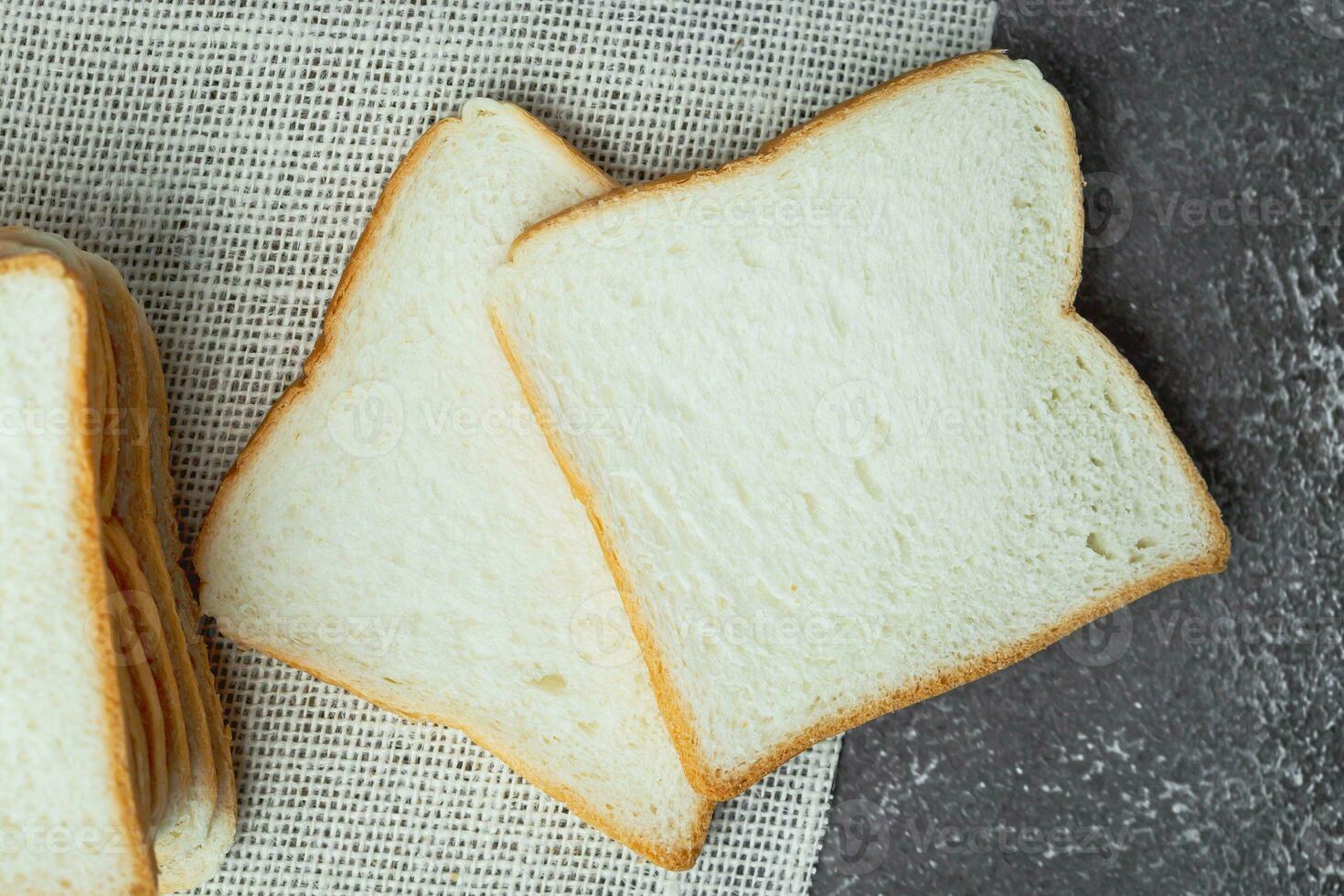 Sliced bread on dark grunge background photo