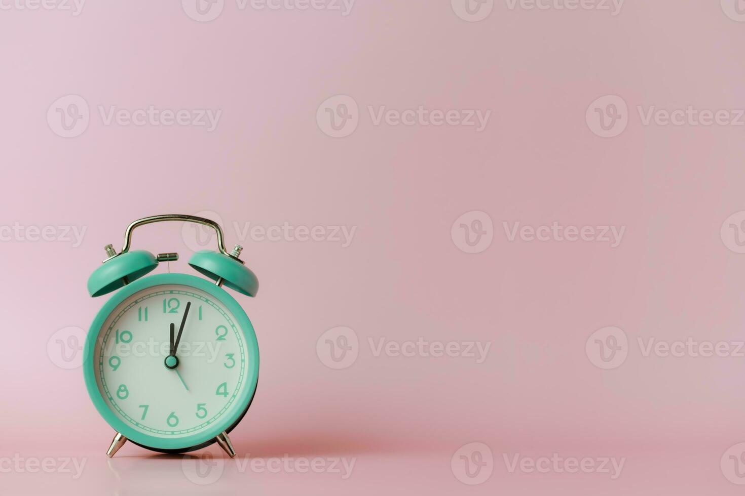 A bell alarm clock on pink background photo