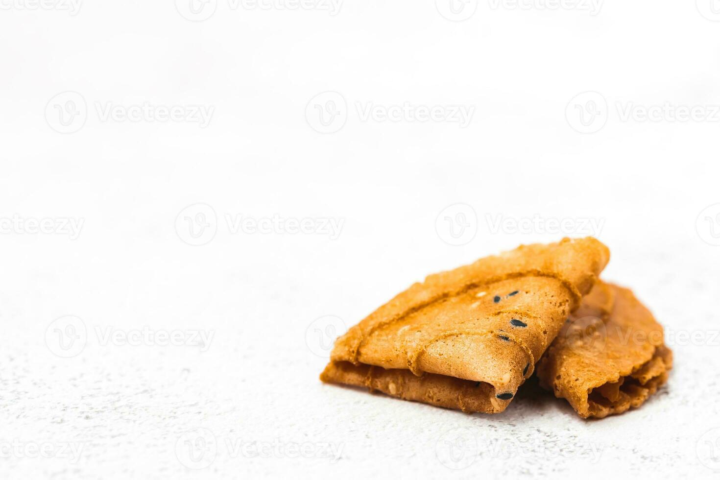 Delicious crispy coconut folded on white background photo