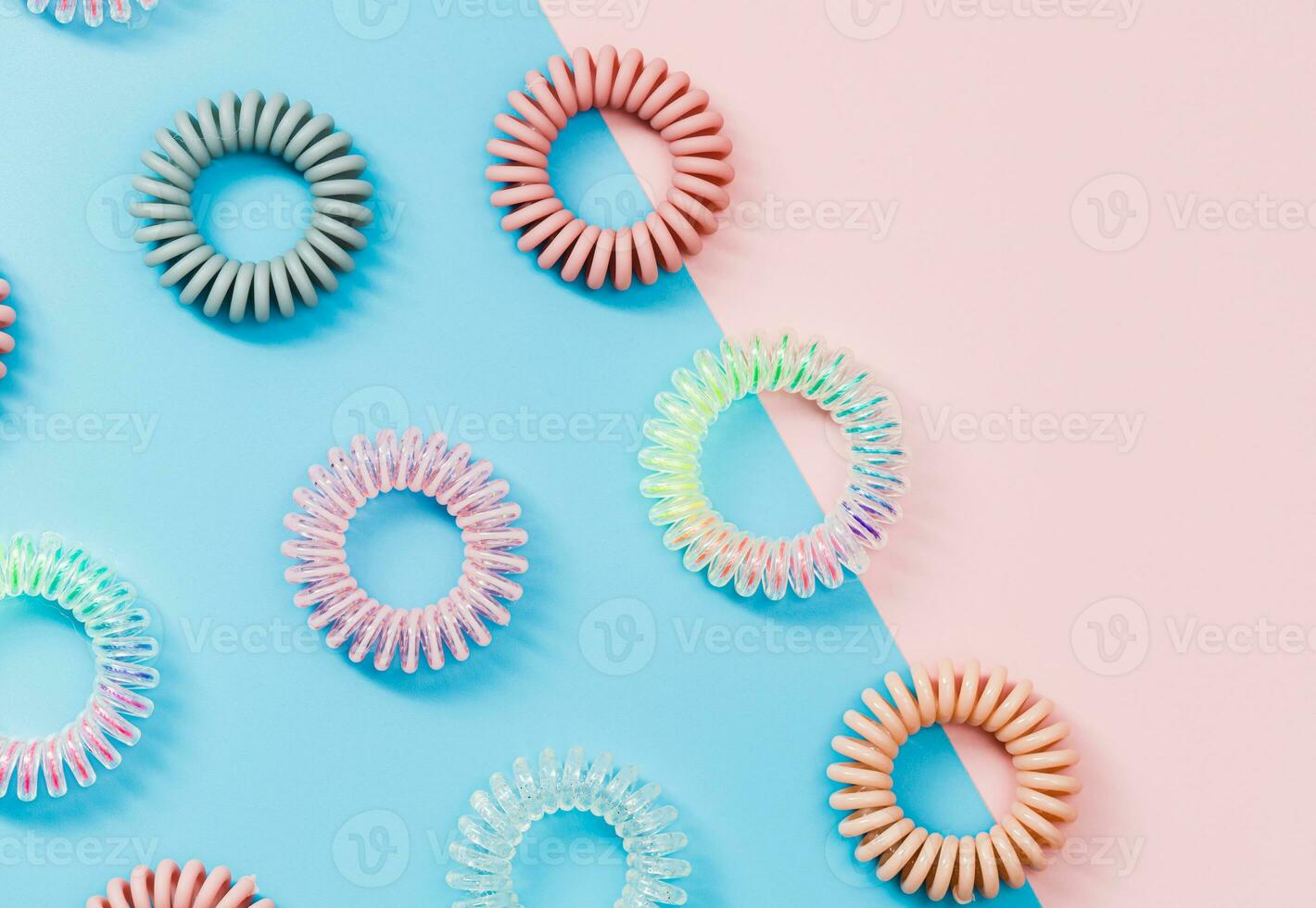 Spiral hair rubber bands on the pastel colour background photo