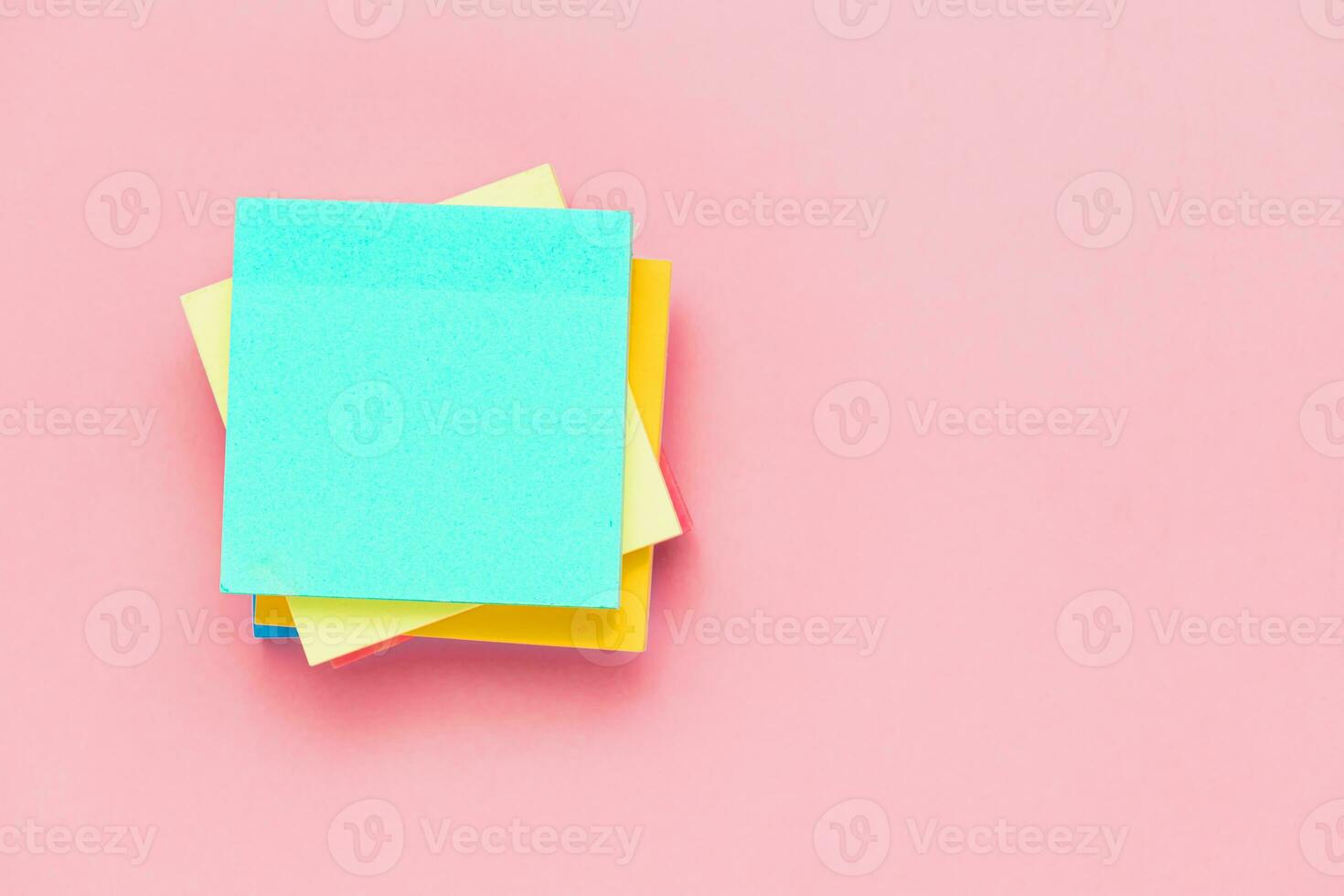 Sticky paper notes on pink background for office and school stationary concept photo