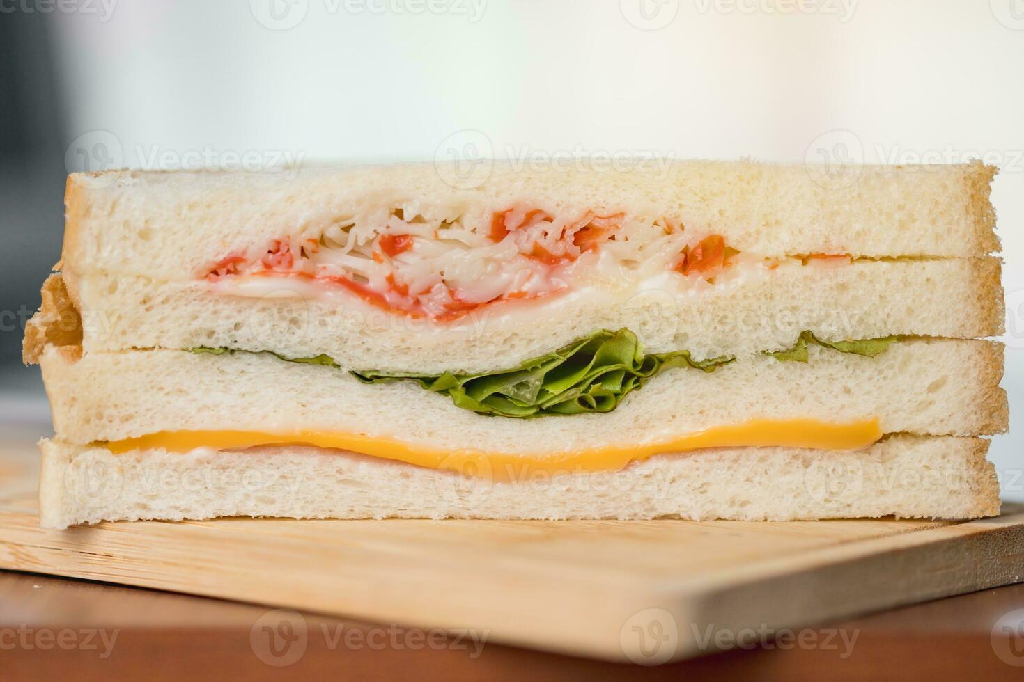 Delicious sandwich bread on a wooden table with blurred background photo