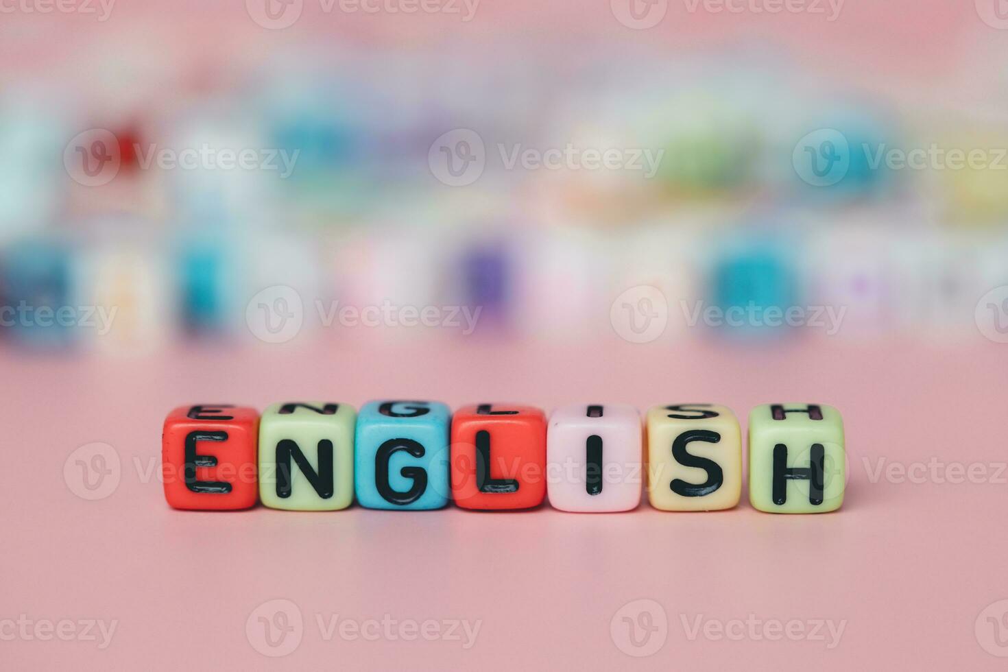 The word ENGLISH from letter beads on pink background photo