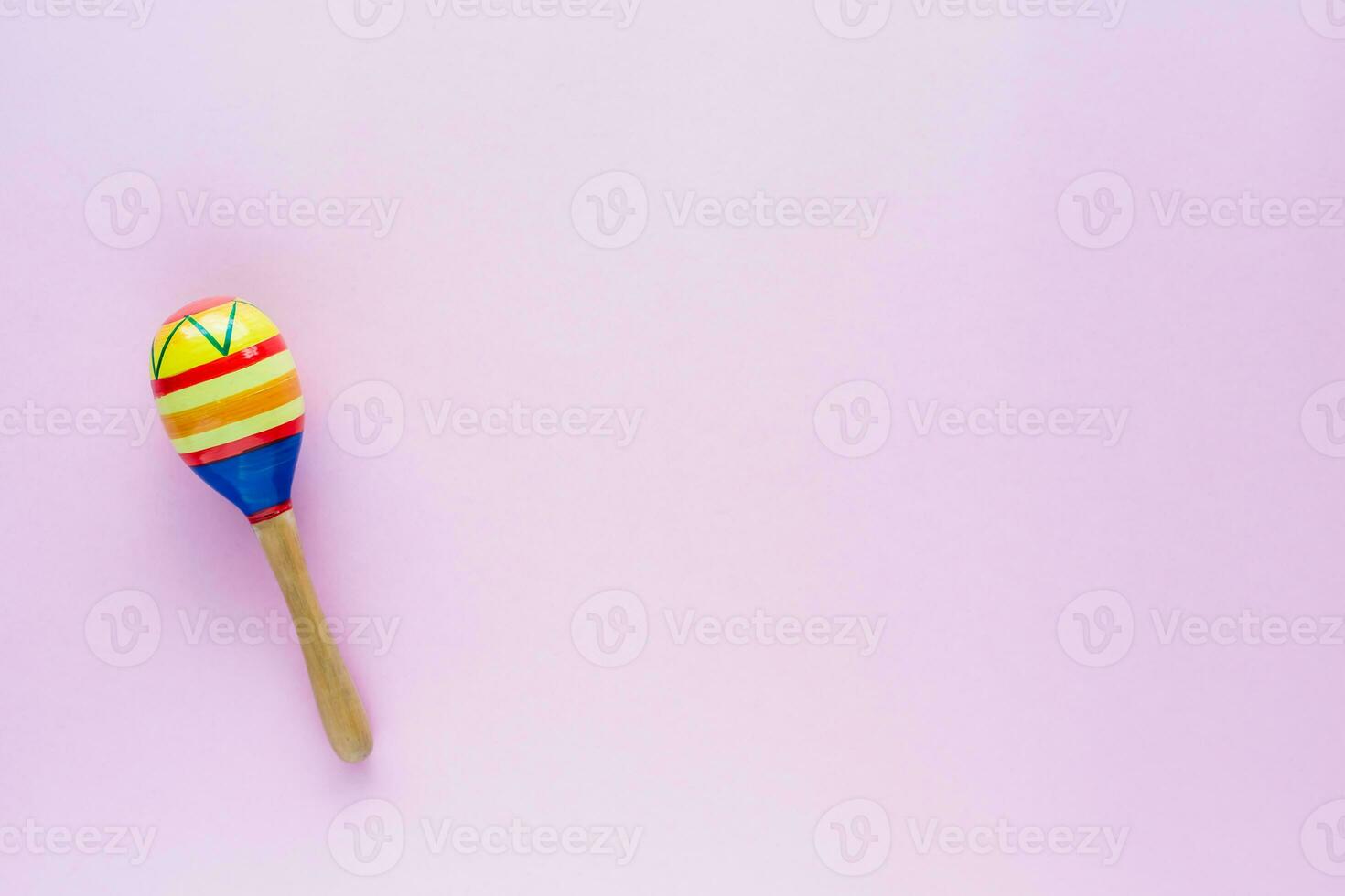 Maracas on pink background photo