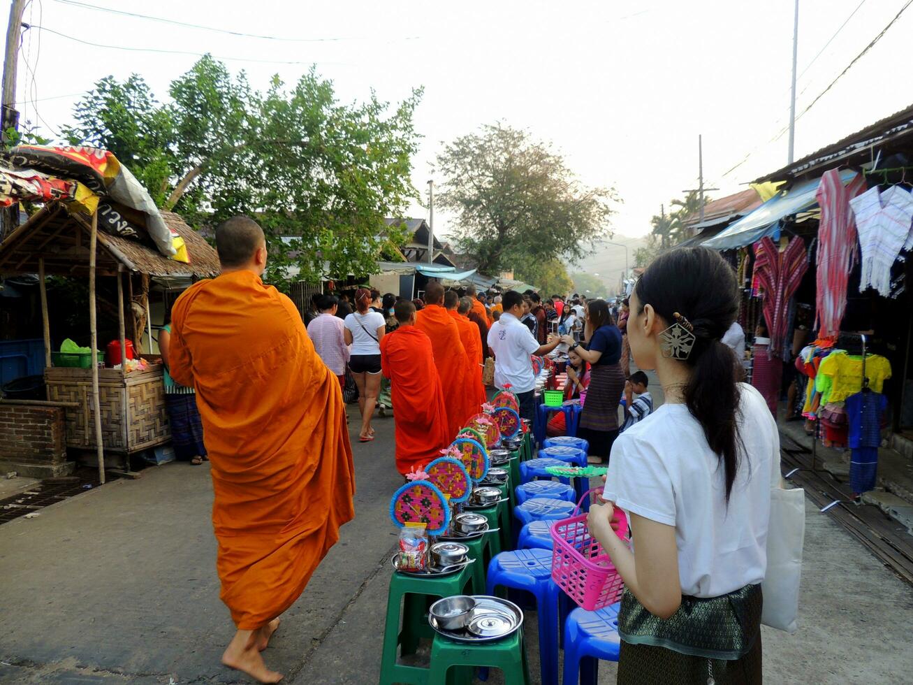 The Pindapata of Thai monks at Saphan Mon Bridge, the Buddhist monk's alms-food gathering, Alms Giving to Monks known as 'Tak Bart' in Thai photo