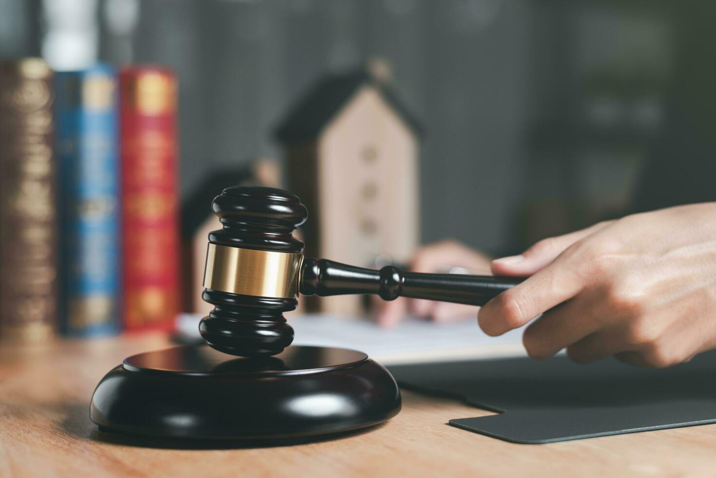 Legal concepts and real estate sales contracts ,Wooden judge gavel on table ,justice in punishment of offenses and criminal verdicts ,legal contract consulting ,Home and Housing Law Judgment photo
