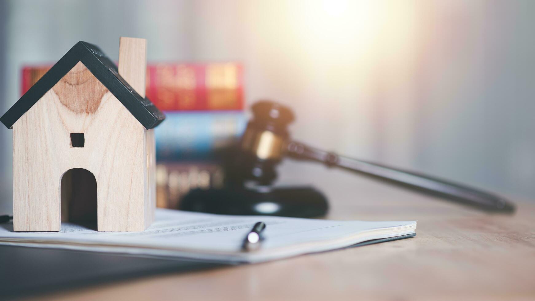 Legal concepts and real estate sales contracts ,Wooden judge gavel on table ,justice in punishment of offenses and criminal verdicts ,legal contract consulting ,Home and Housing Law Judgment photo