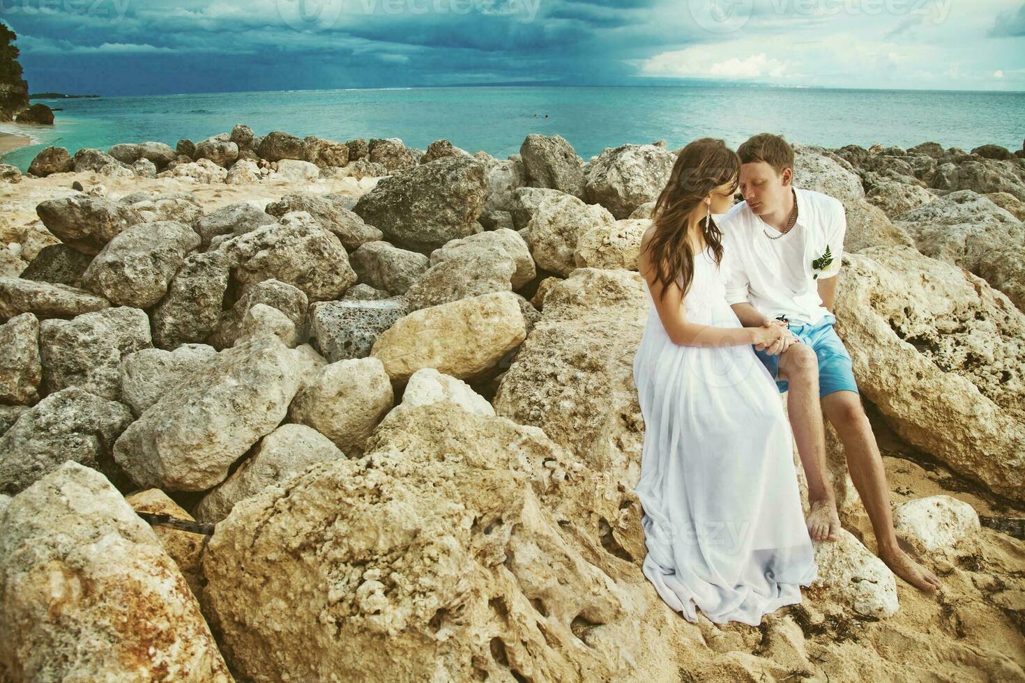 Newly married couple on the beach. Wedding and honey moon concept photo