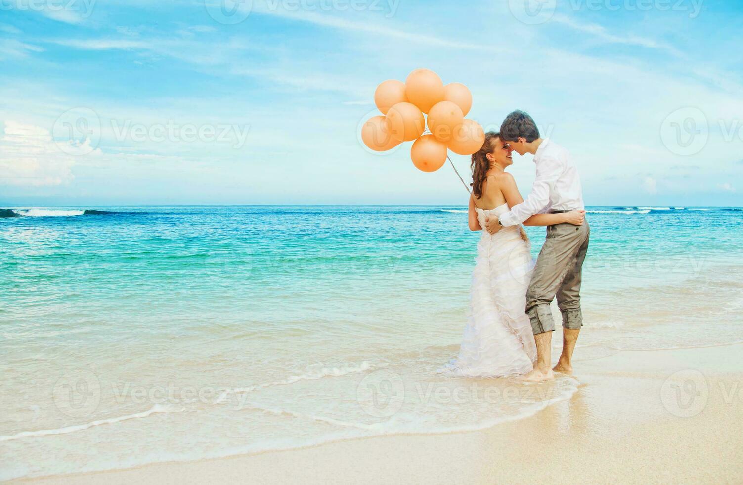 Newly married couple on the beach photo