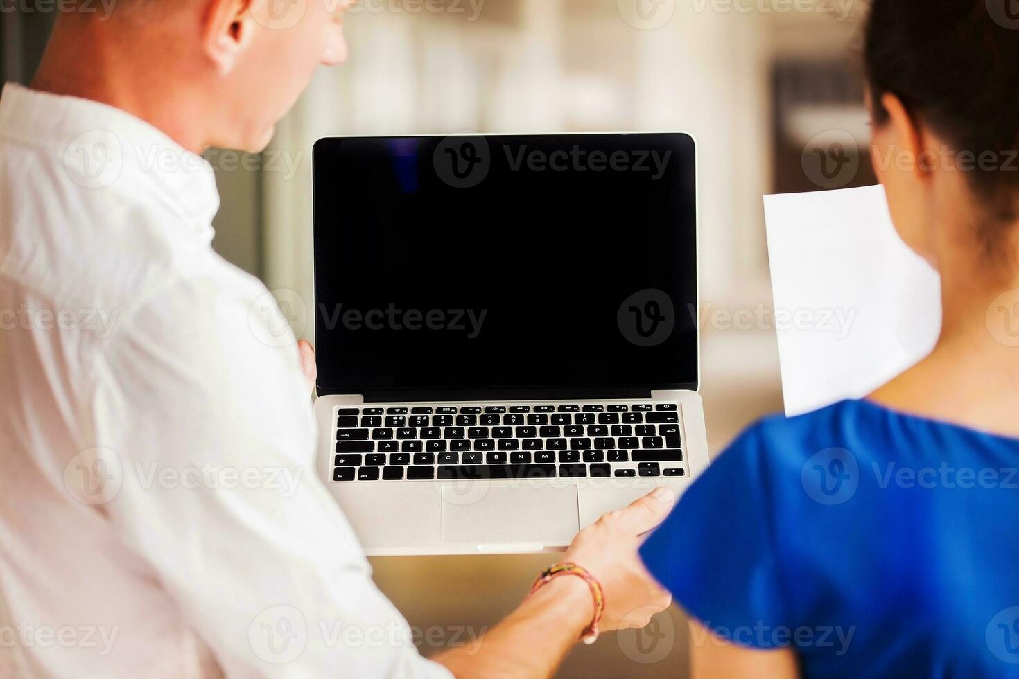 two office workers looking at the empty laptop screen. Website design template photo