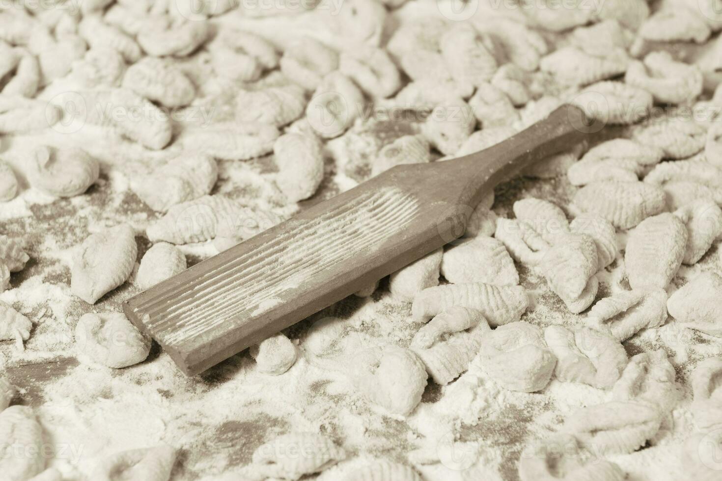 Hands kneading dough for gnocchi. photo