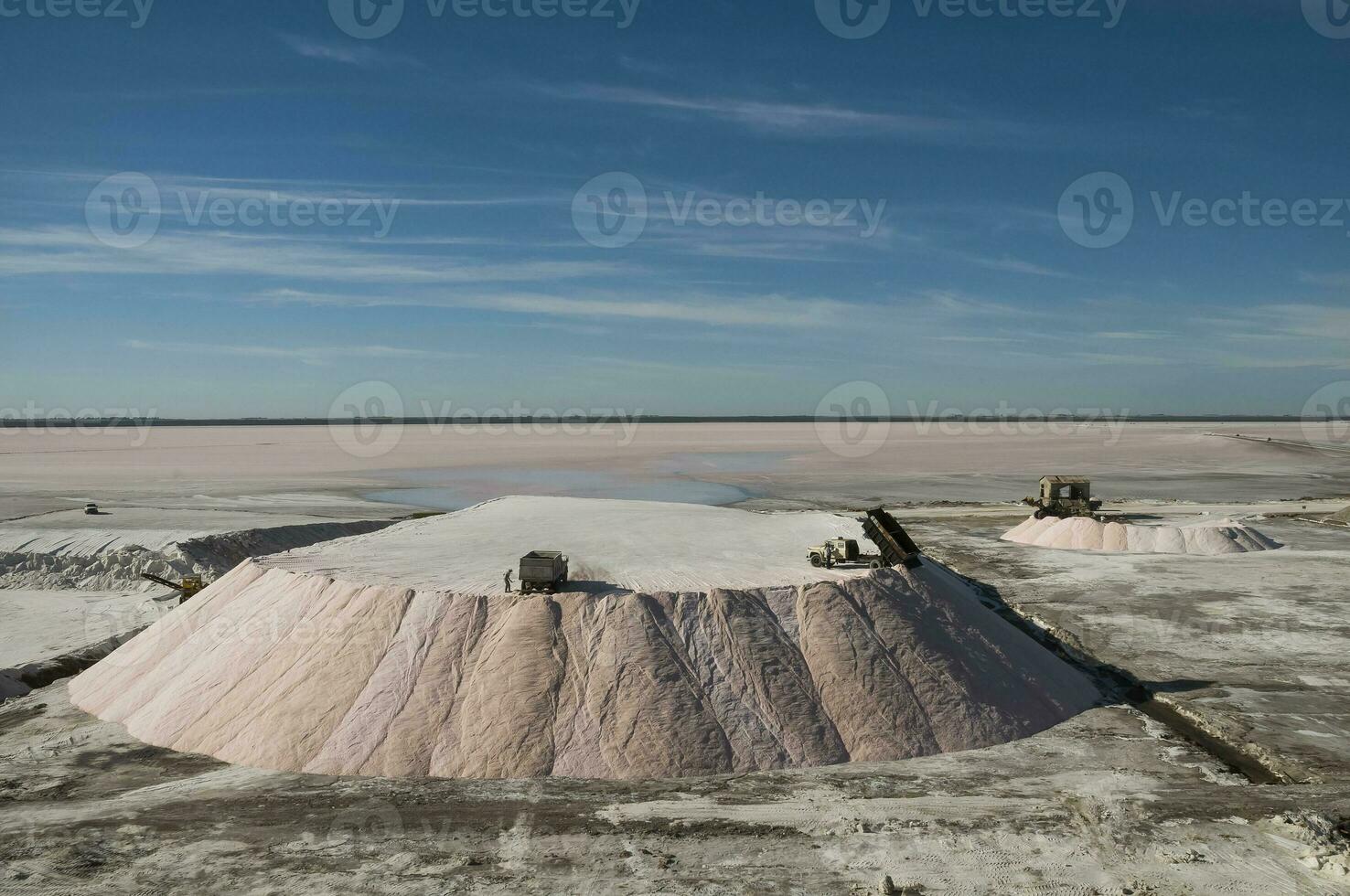 Trucks unloading raw salt bulk, Salinas Grandes de Hidalgo, La Pampa, Argentina. photo