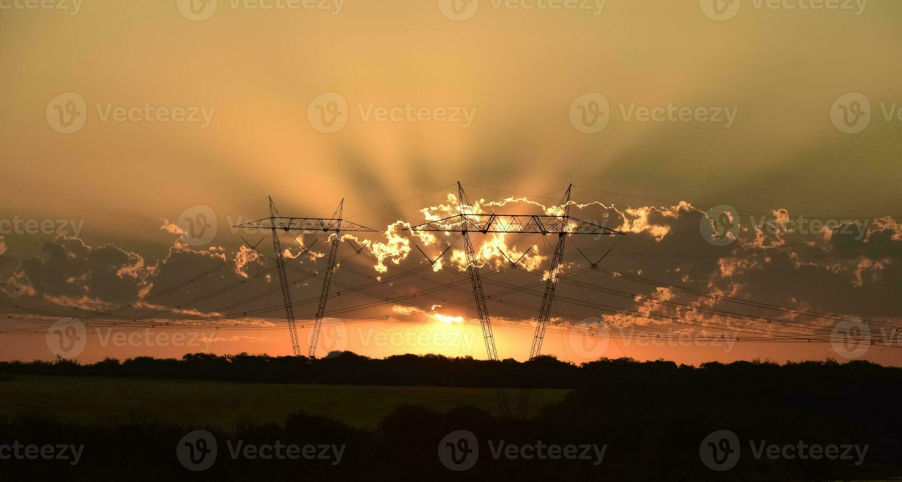 High voltage power line at sunset, Pampas, Argentina photo