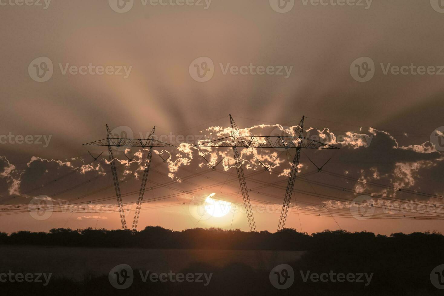 High voltage power line at sunset, Pampas, Argentina photo