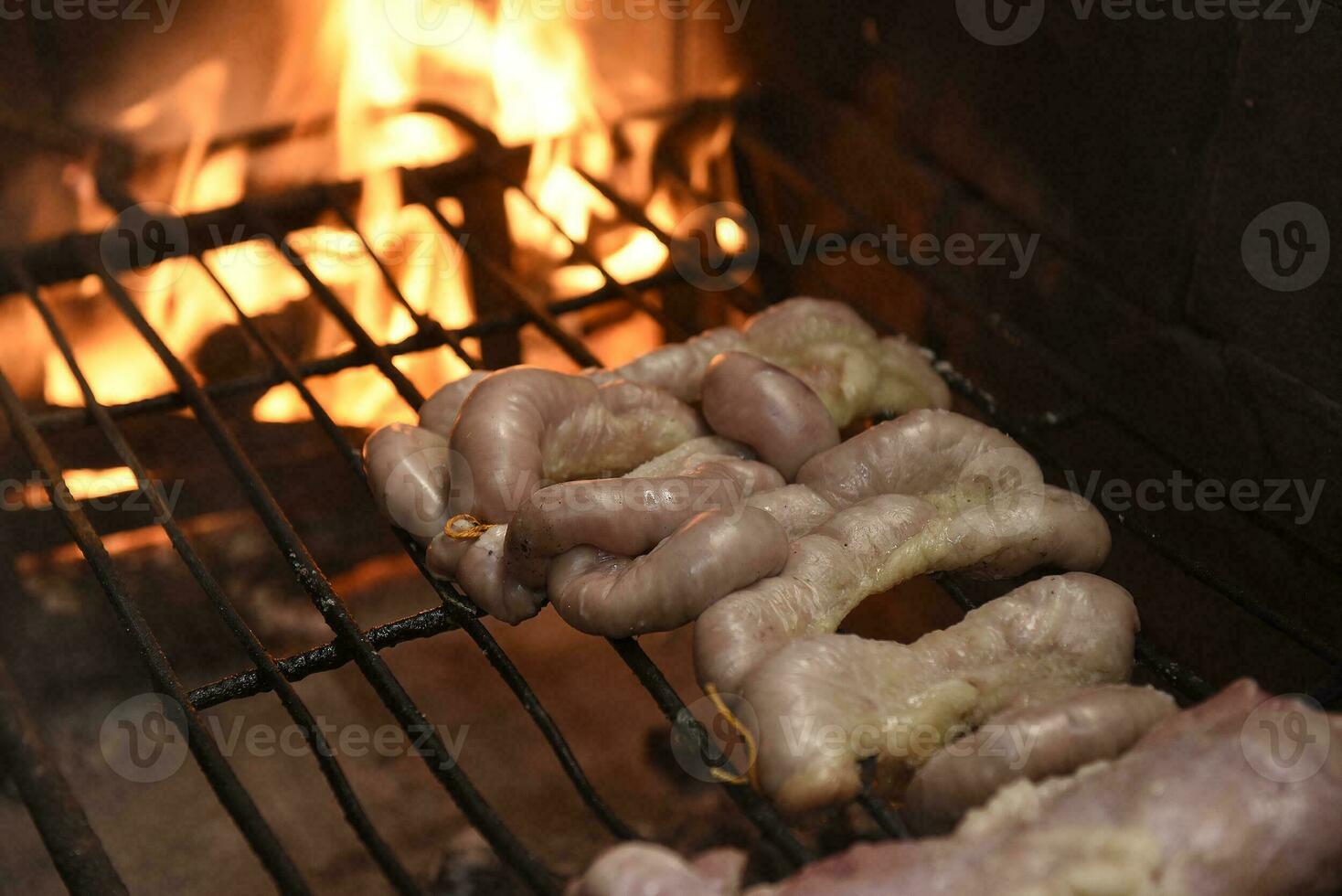 Cow bowels presented on a wooden board with ingredients, ready to grill photo