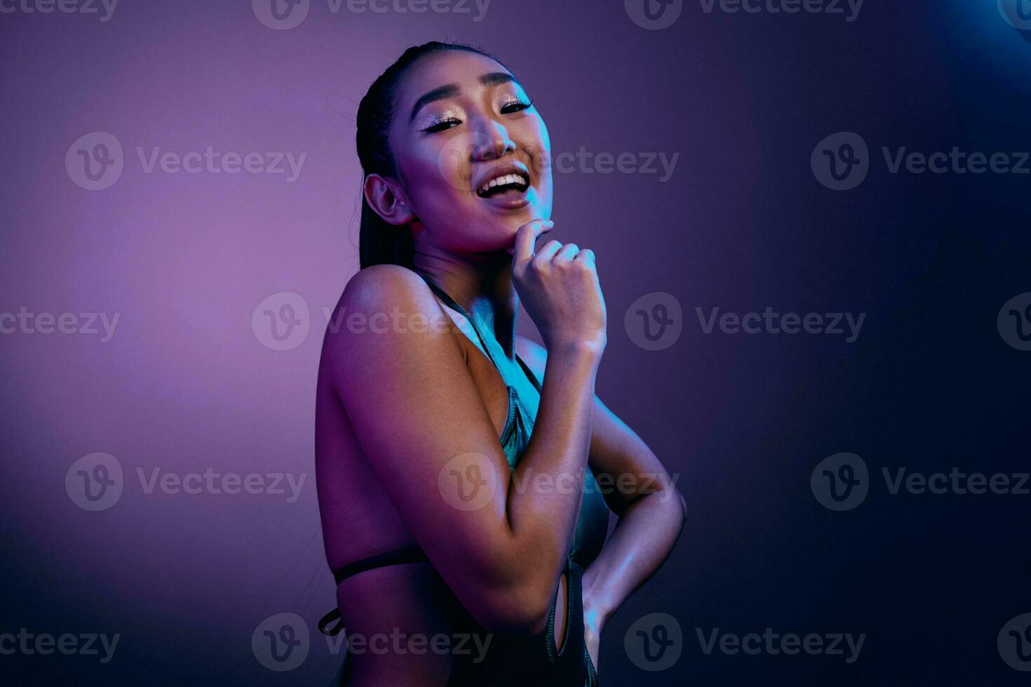 Young woman purple neon colorful fashion blue light disco beauty trendy photo