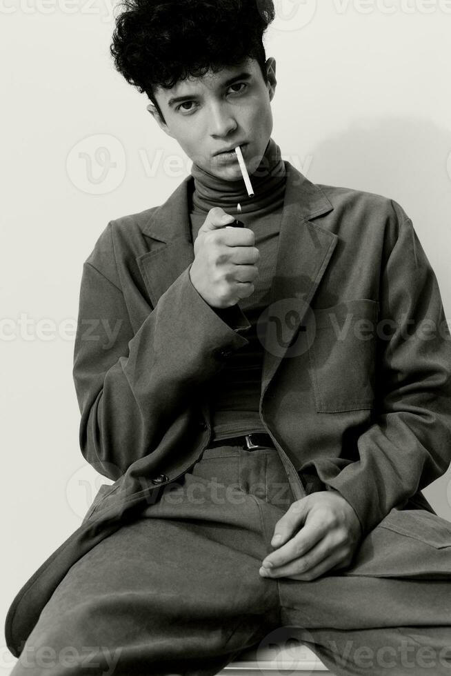 Man and student portrait white serious fashion sitting black thoughtful hipster smoking cigarette photo