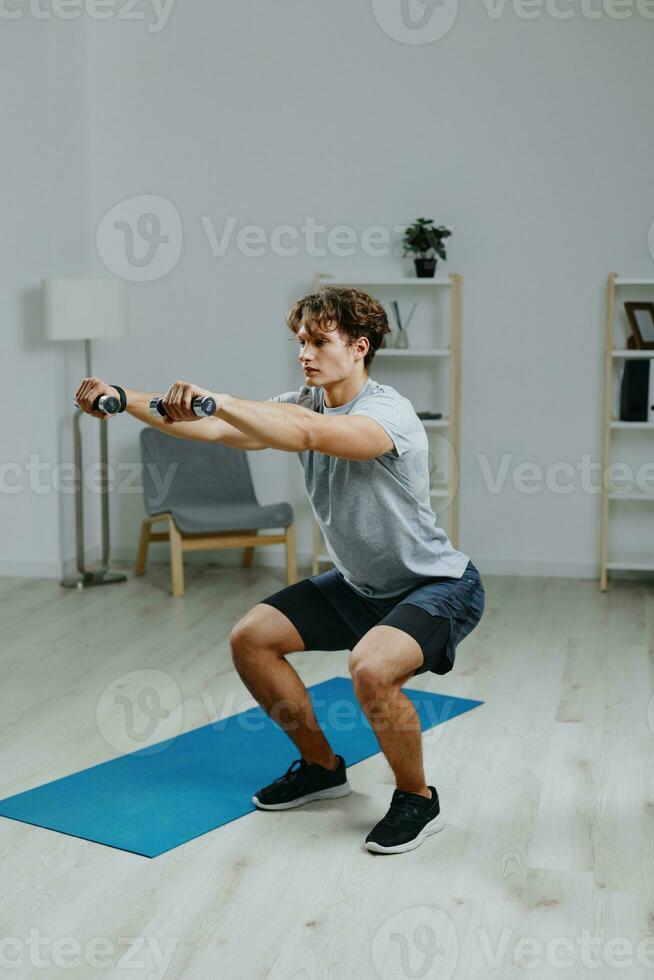 man indoor dumbbells muscular home health sport activity lifestyle gray training photo