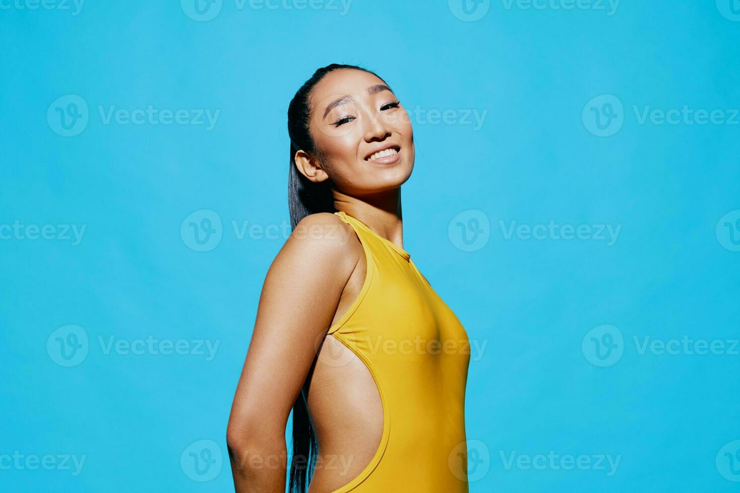 Woman yellow portrait blue background lifestyle smile beauty trendy surprised happiness brunette fashion photo