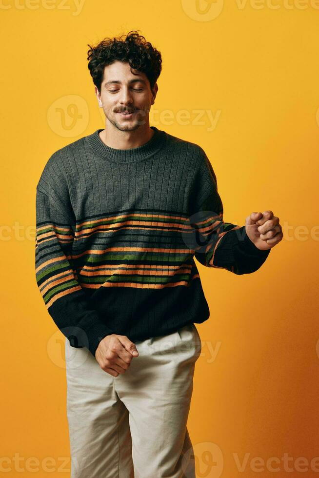 White man smile posing orange sweater portrait background happy standing trendy fashion student photo