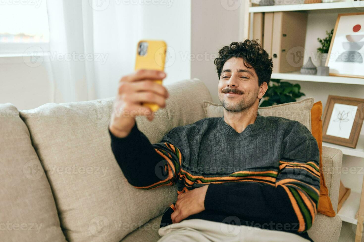 Lifestyle man communication typing technology selfie comfortable phone sofa message home photo