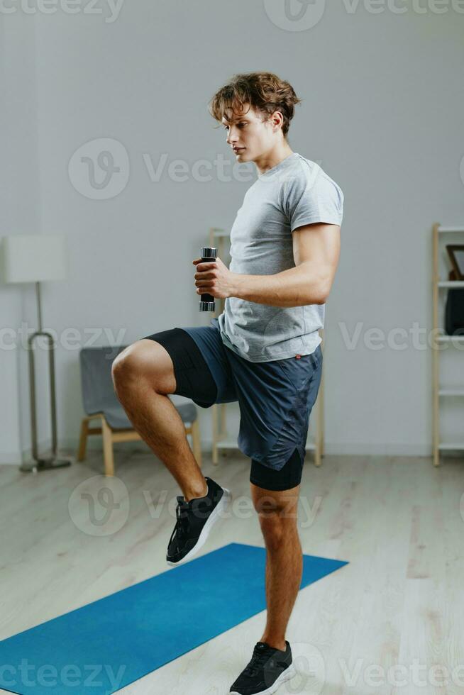 man lifestyle stretching indoor gray dumbbells home health sport activity training photo