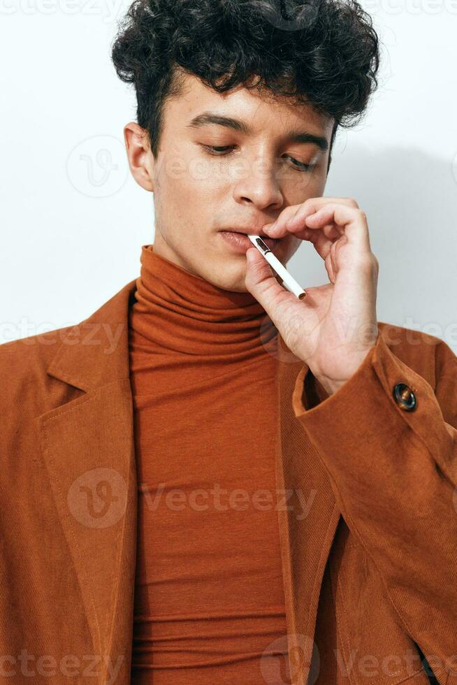 Man thoughtful smoking sitting student fashion lifestyle cigarette portrait beige light photo