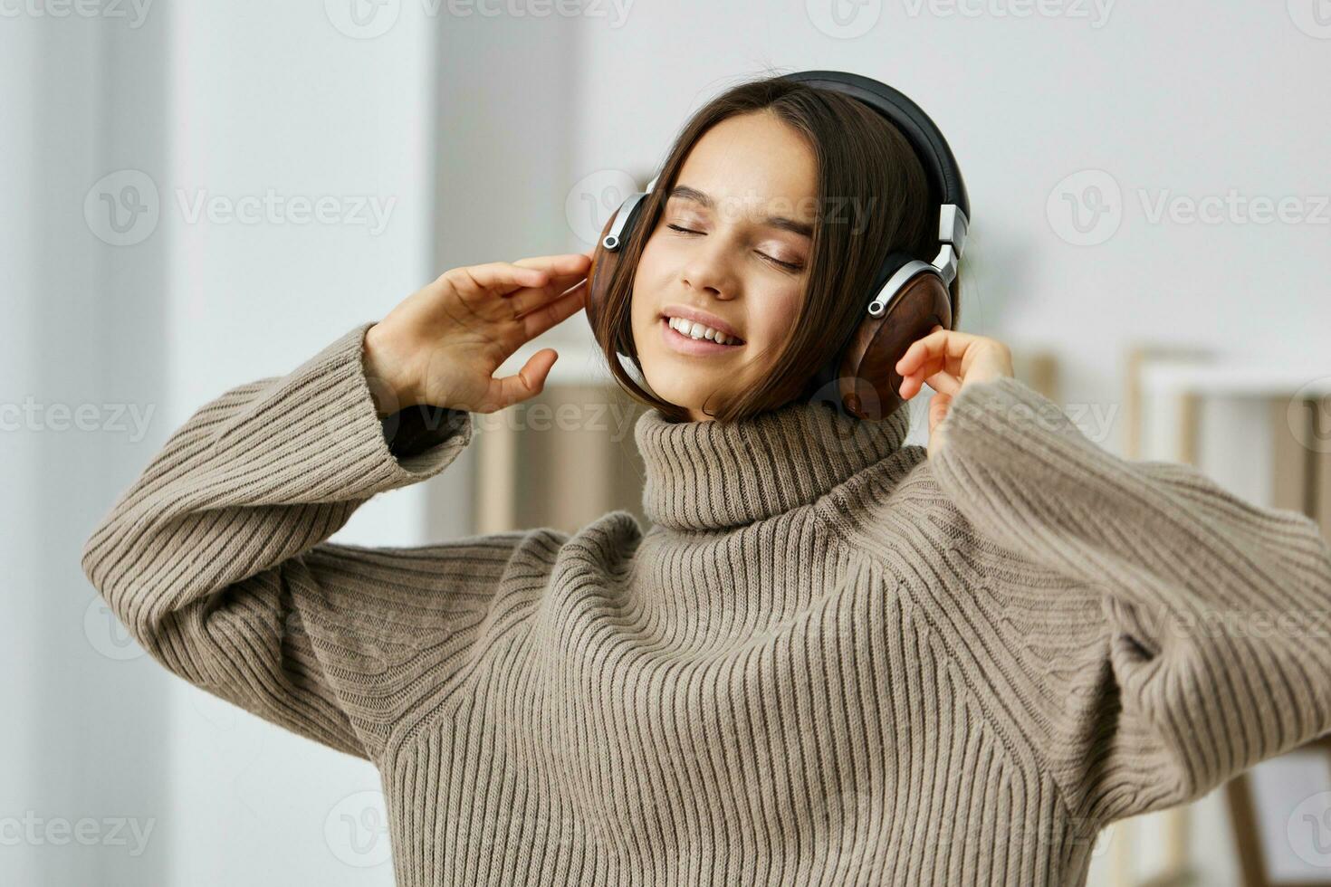 student woman indoor caucasian earphones happy young headphones listen home music photo