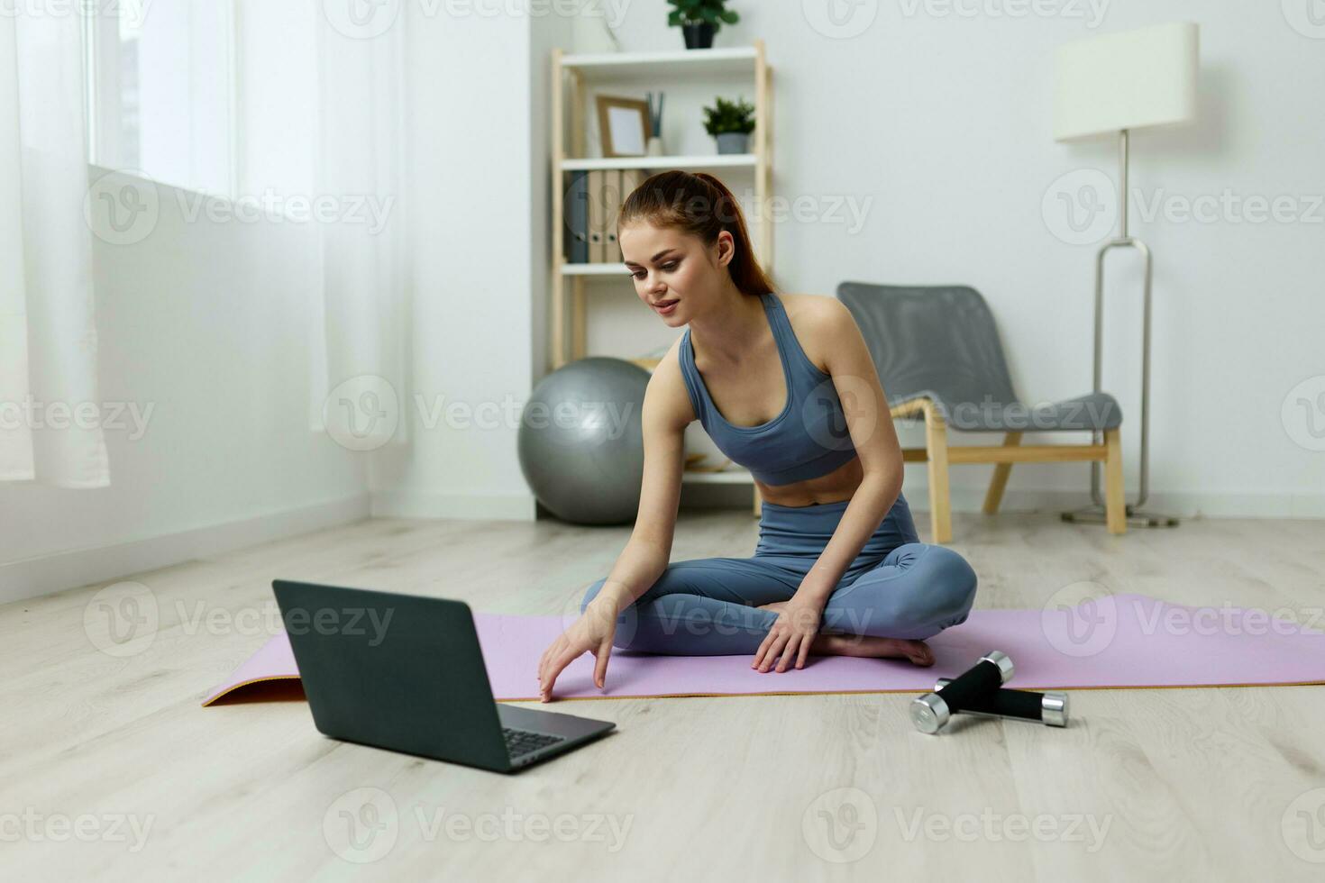 lifestyle woman exercise video health laptop training lotus mat yoga home photo