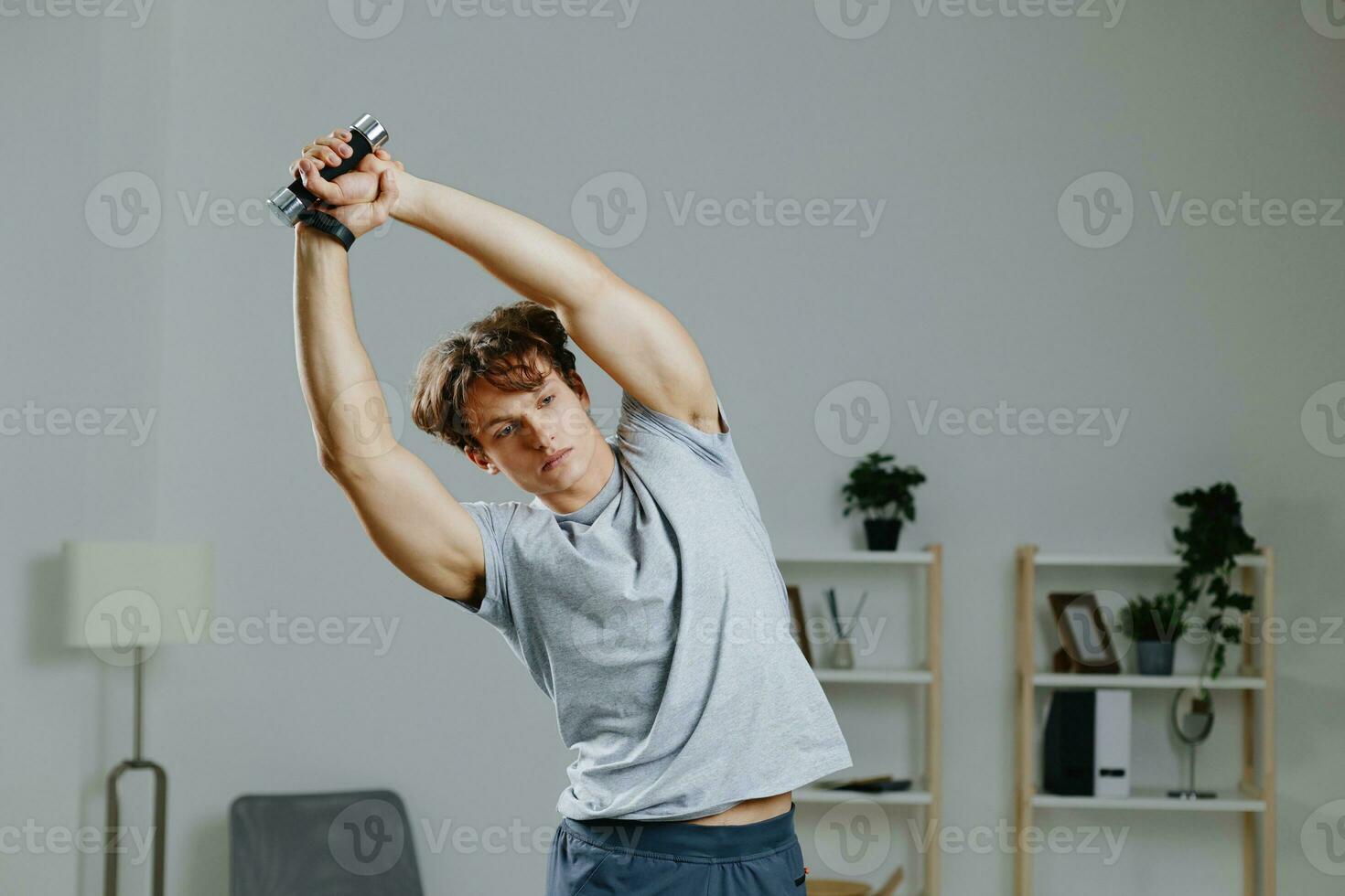 man indoor room dumbbells gray health activity home training lifestyle sport photo