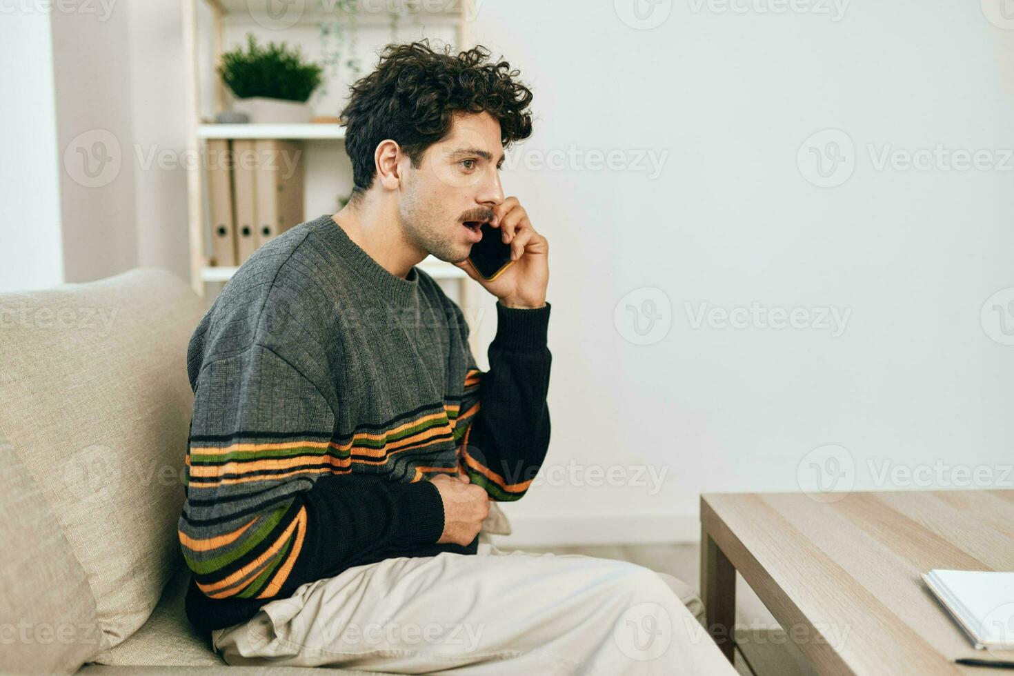 Couch man technology smartphone talking attractive freelance smile lifestyle sofa home sitting phone cell photo