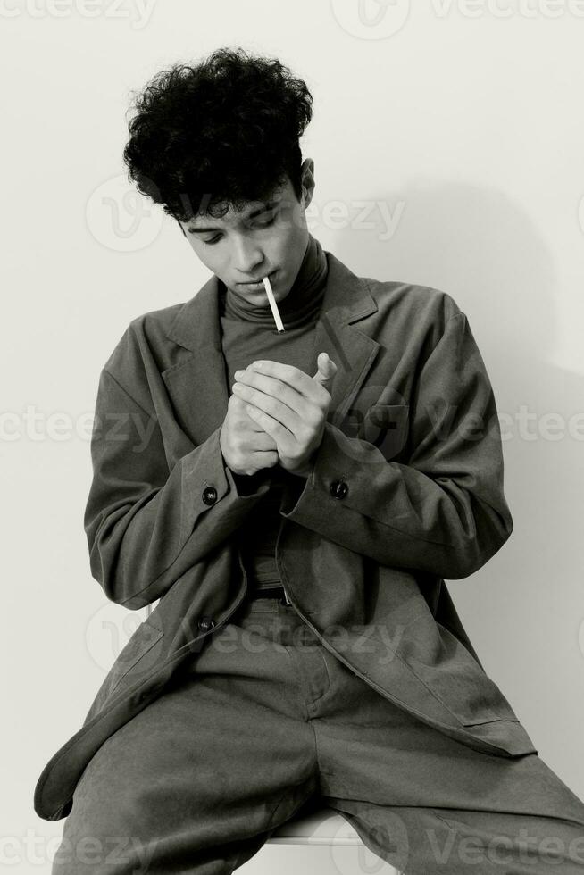 And man thoughtful hipster sitting model portrait smoking posing fashion white cigarette black student photo