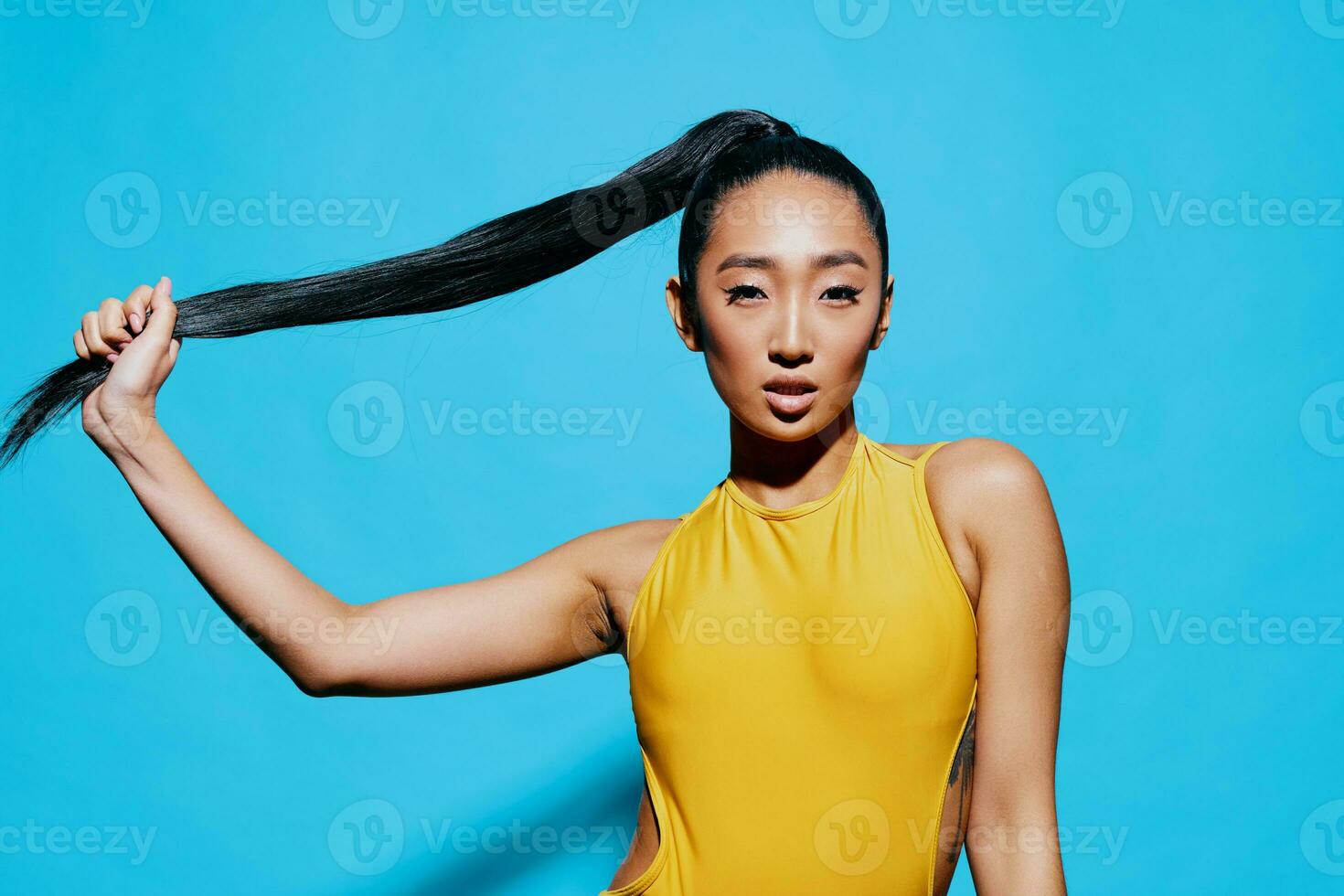 Amazed woman beauty surprised lifestyle trendy portrait studio yellow smile blue fashion photo