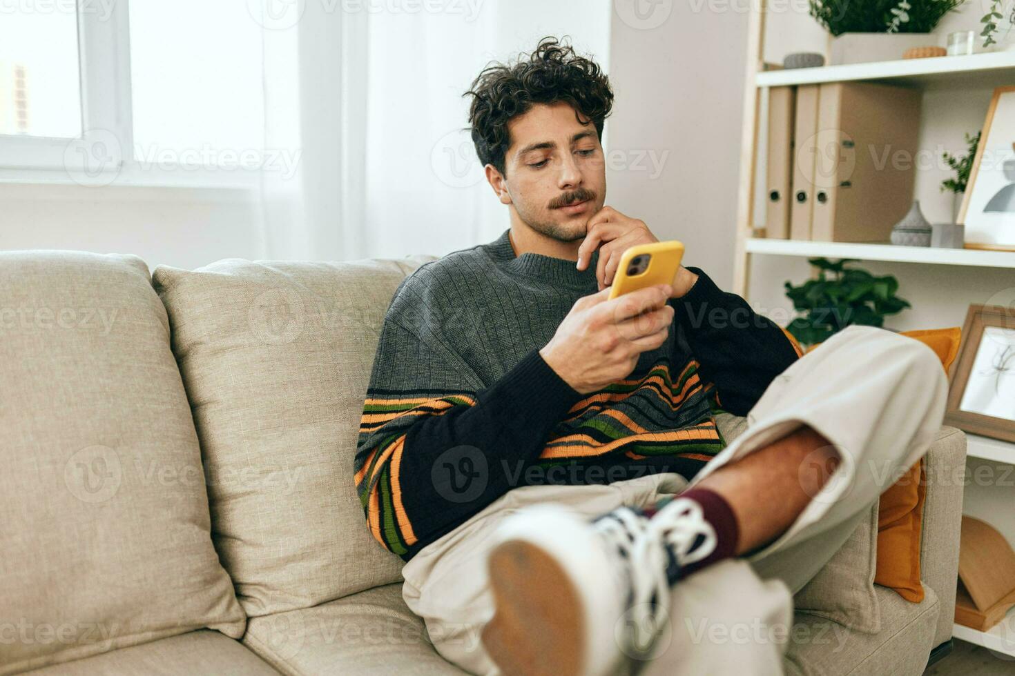 Man message business home technology communication freelance typing phone sofa lifestyle casual photo