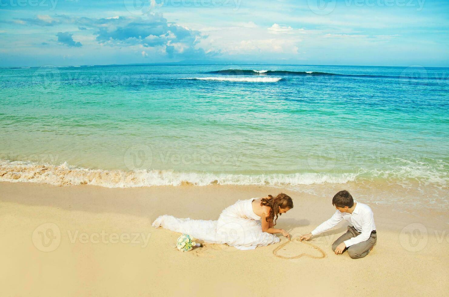 Newly married couple on the beach photo