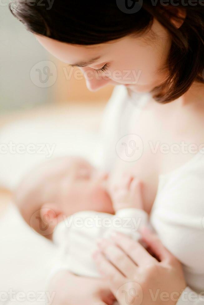 Mother breastfeeding her child photo