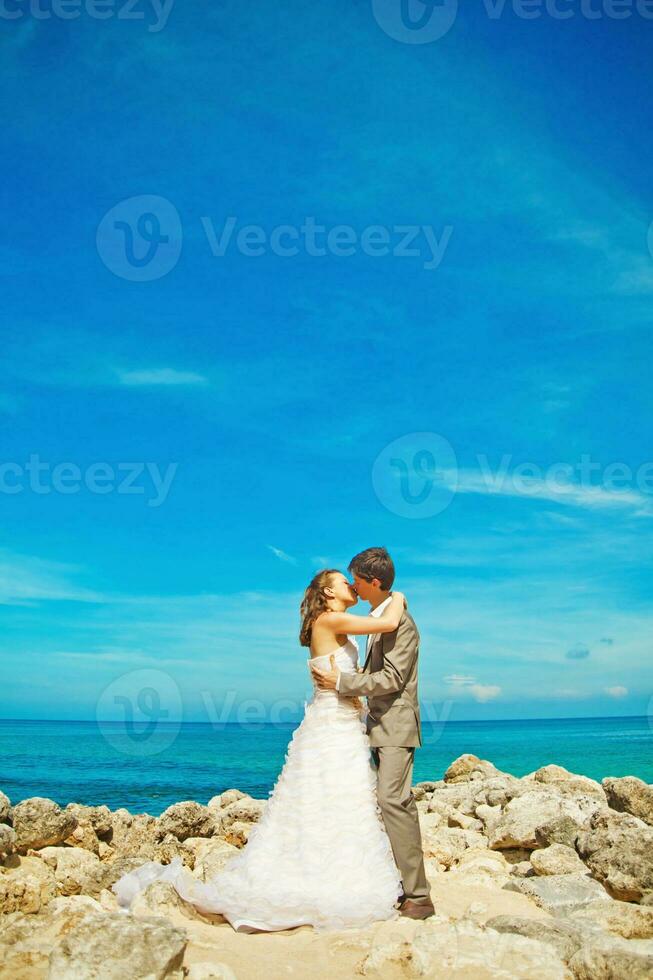 Newly married couple on the beach photo