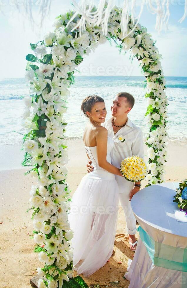 Newly married couple on the beach photo