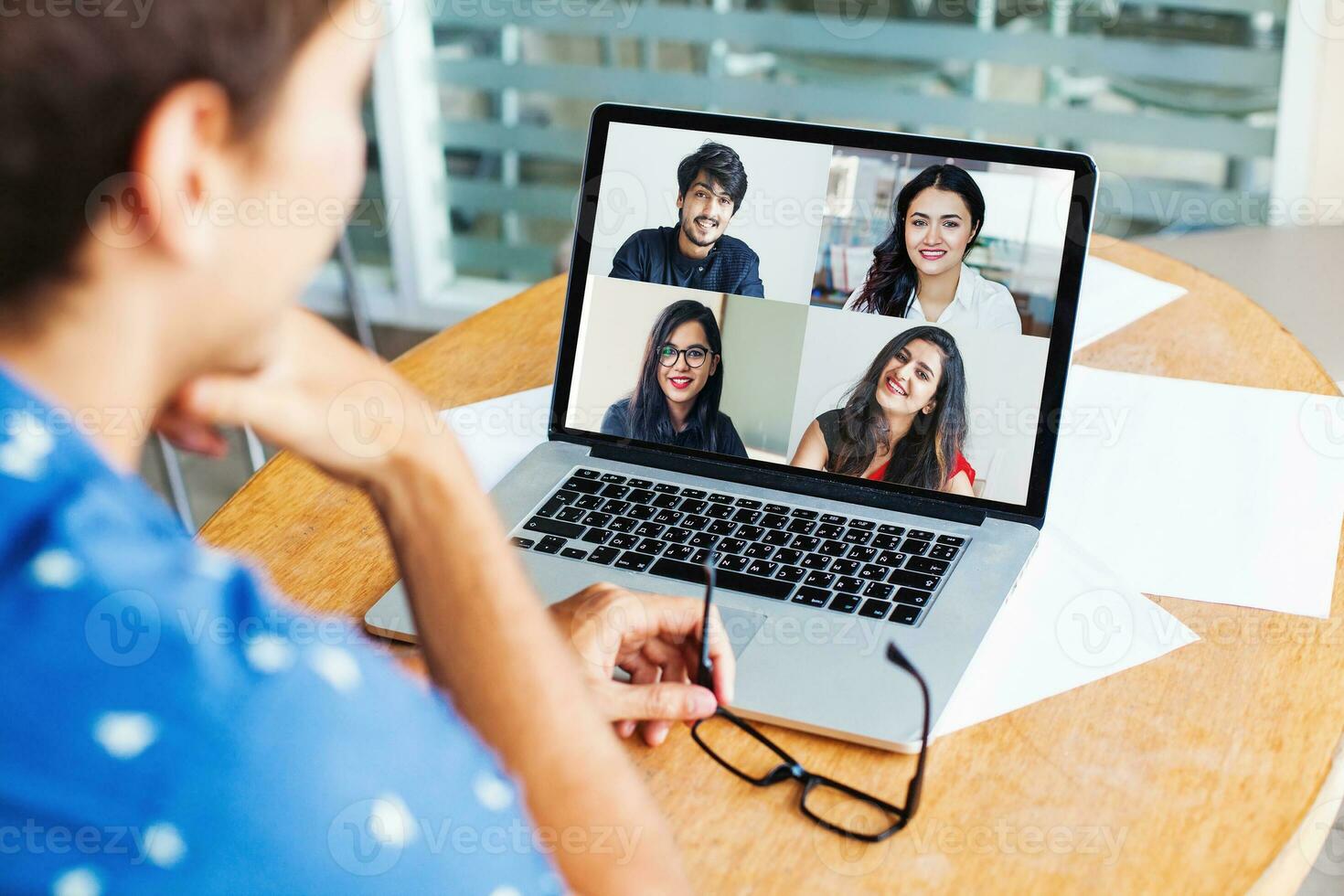 Remote teamwork concep. man talking to his Indian colleagues on video call photo