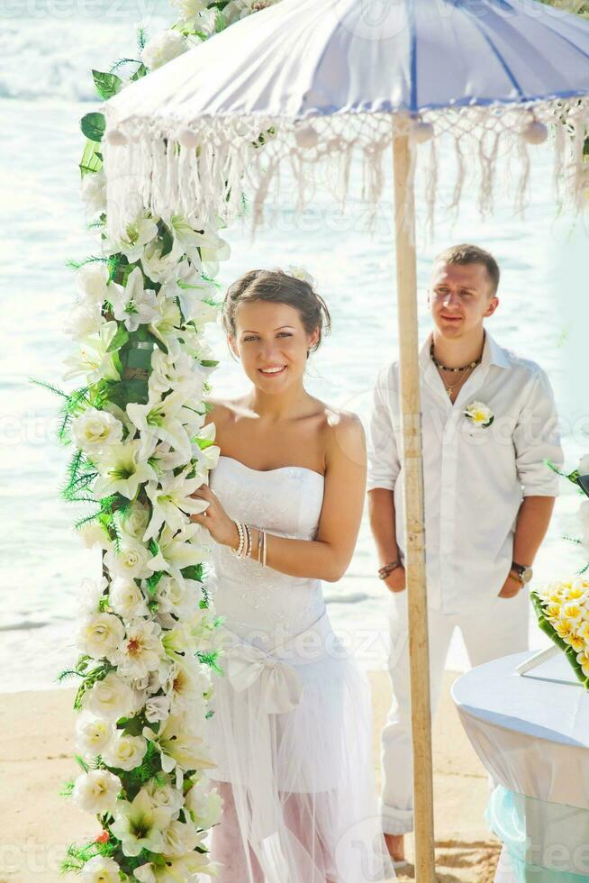 Newly married couple on the beach photo