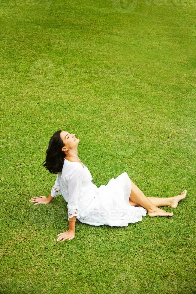 Beautiful woman on the grass photo