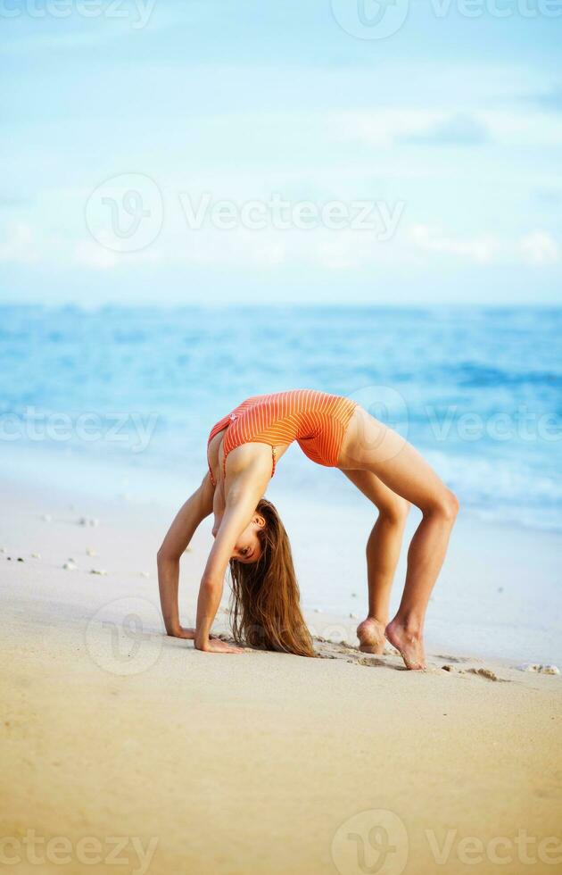 Beautiful young woman at the beach photo